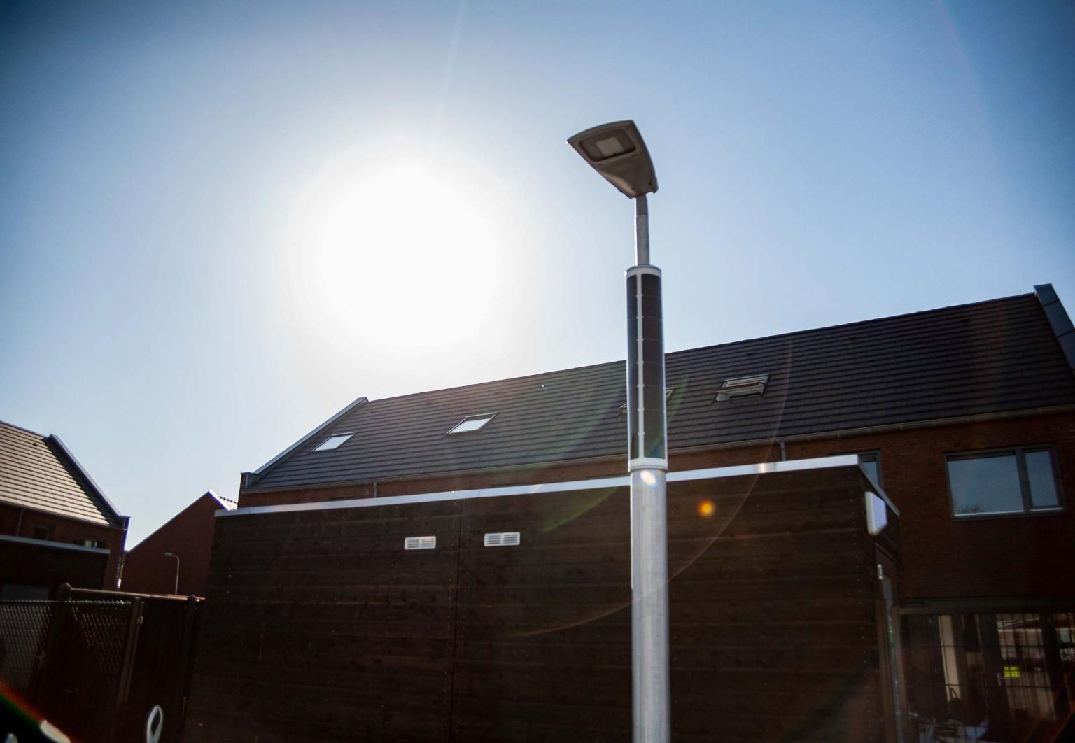 Solar powered parking lot lighting with the sun shining